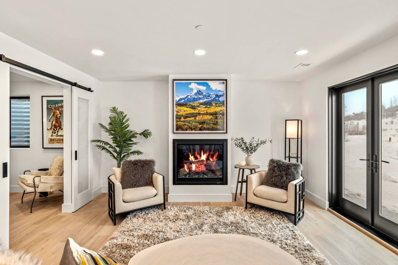Living room with floor-to-ceiling windows and a gas fireplace